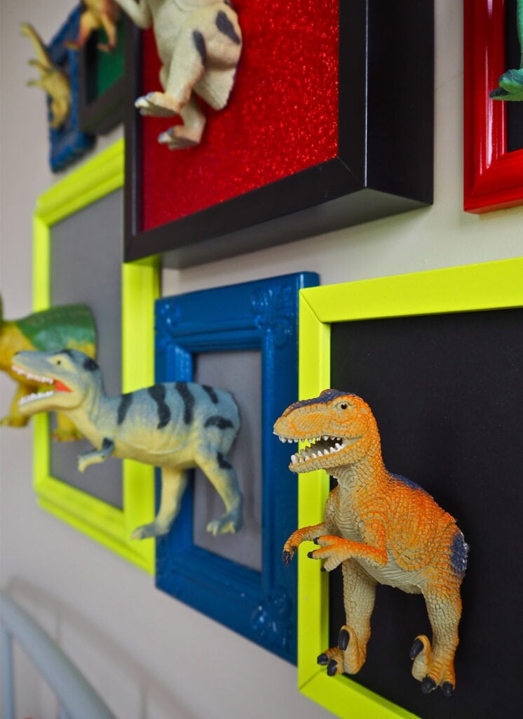 mounted toy dinos in painted picture frames