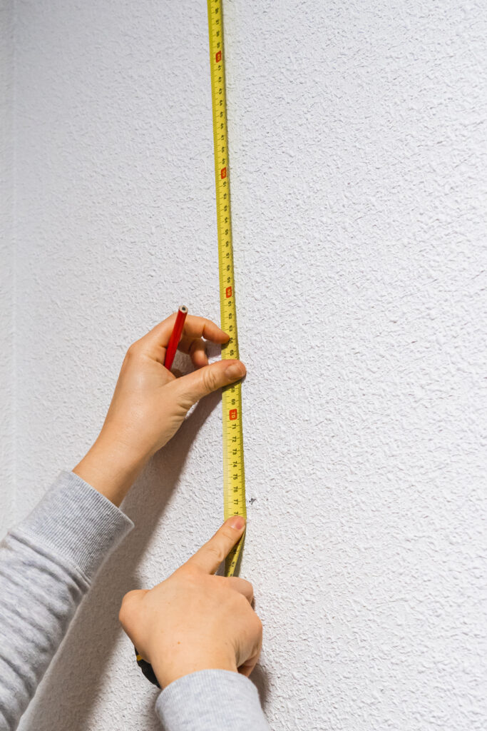 measuring tape against a white wall.