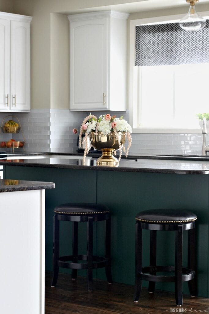 green island and white cabinets in two toned kitchen