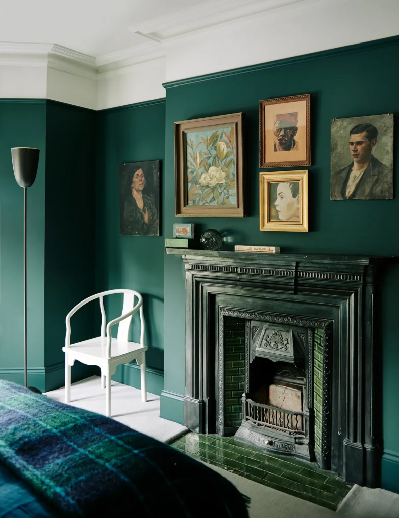 art covered green accent wall in a guest room