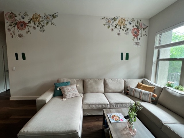 Living room with floral decals with coach and table.