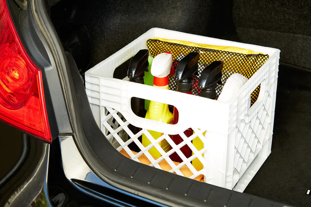 stackable milk crate filled with automotive products stored in a trunk