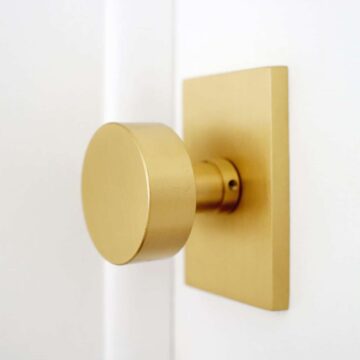 modern brass doorknob on a white door