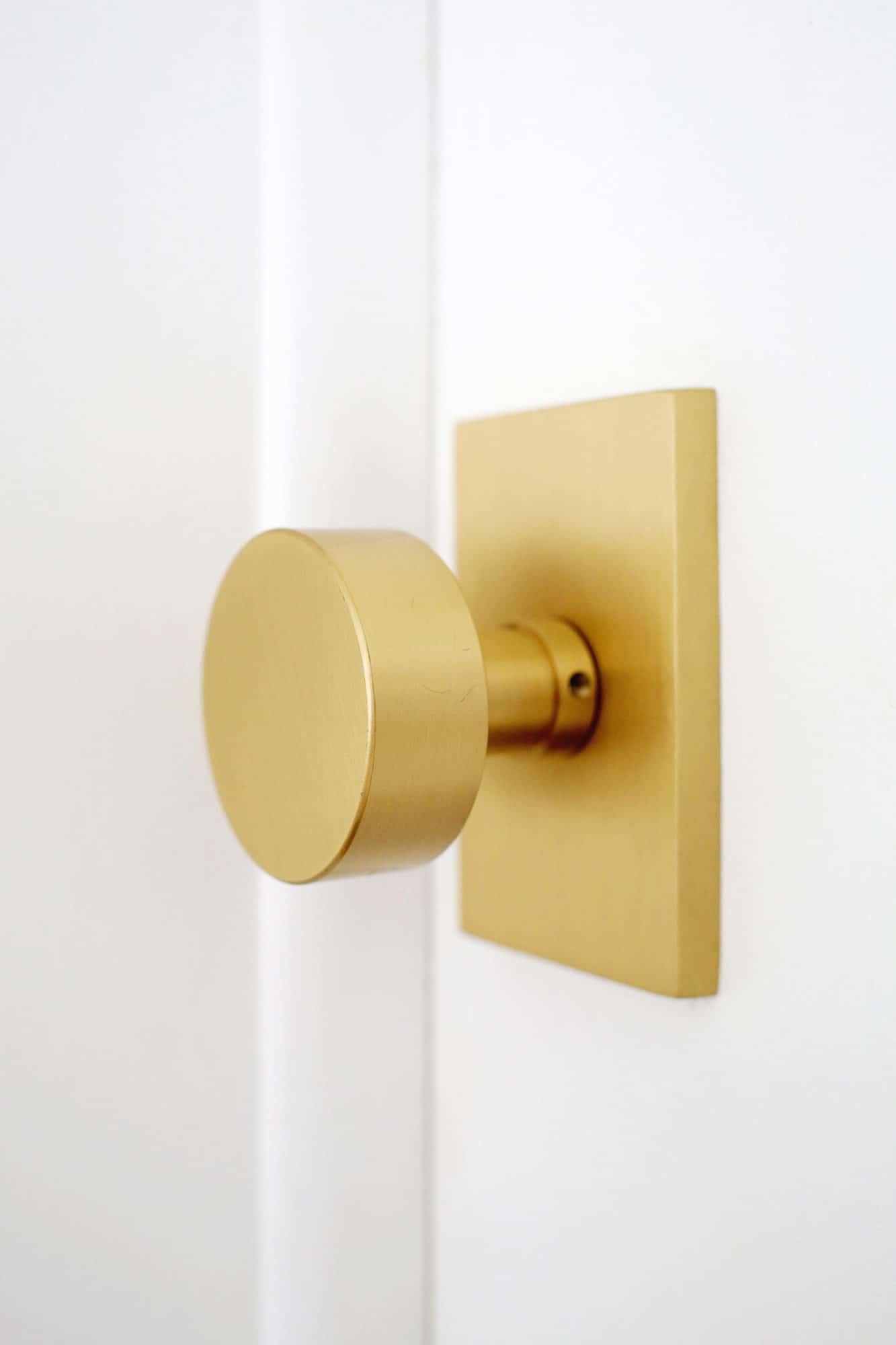 modern brass doorknob on a white door