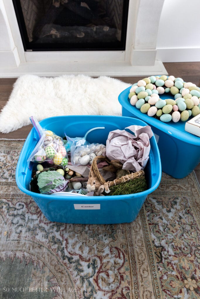 blue storage bins with easter decor inside