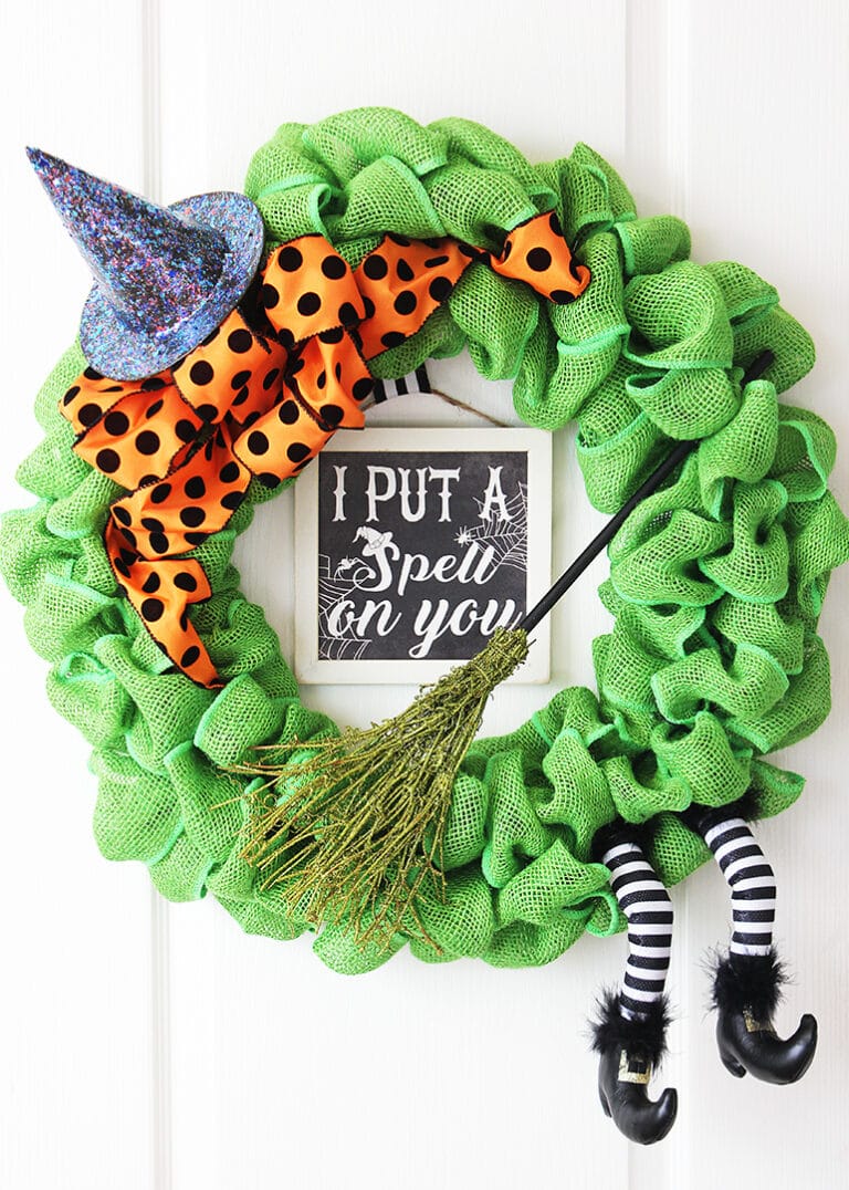 Green burlap DIY Halloween wreath with witchy accents.