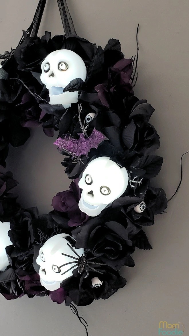 Solar skulls attached to a black base for Halloween wreath ideas.