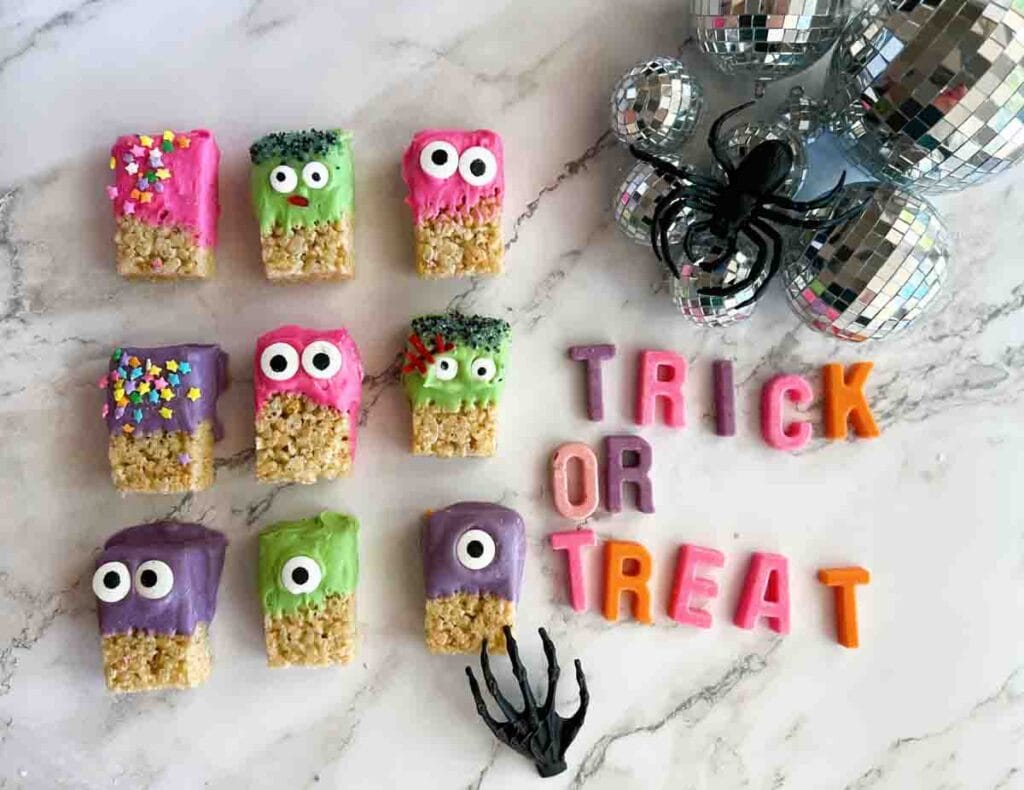 Colorful Halloween Rice Krispie treats on a marbled counter. 