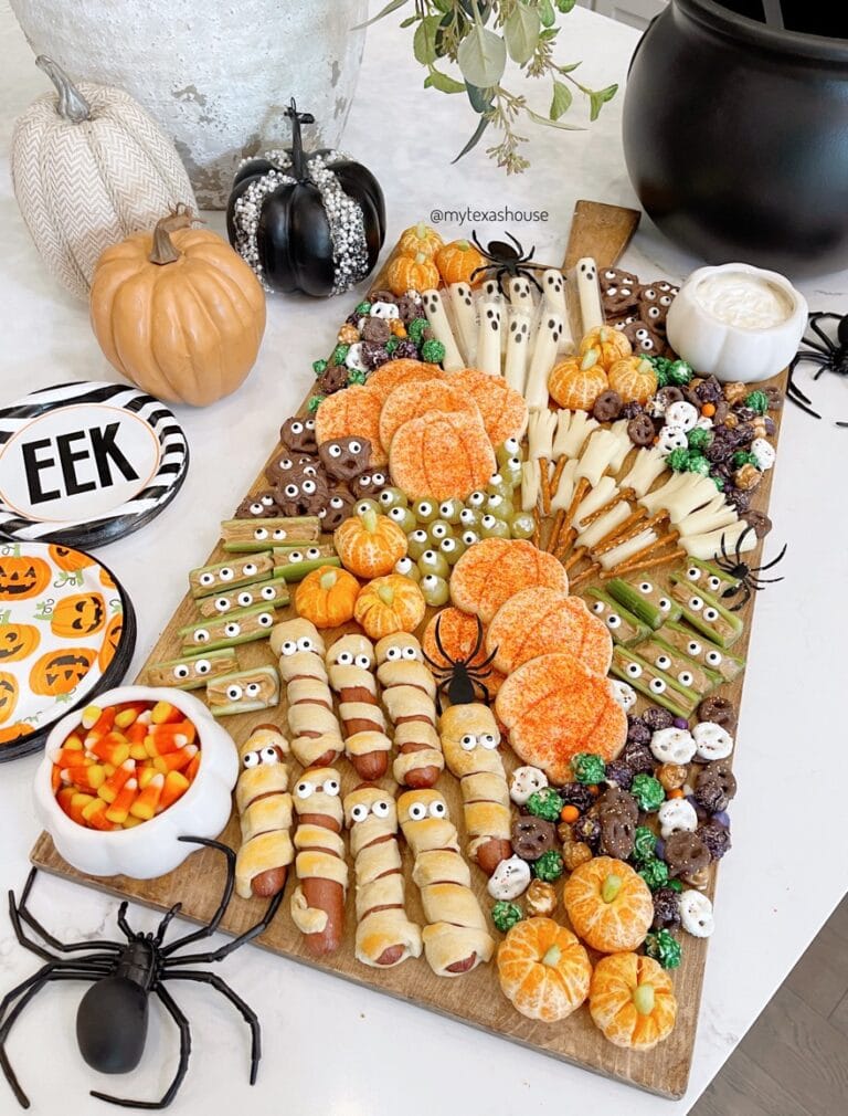 kid friendly halloween charcuterie board with green and orange scheme