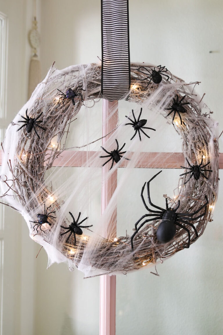Spiderweb inspired wreath. hanging on a window.