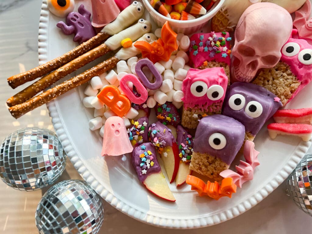 chocolate dipped rice krispie treats & pretzels with candy eyes