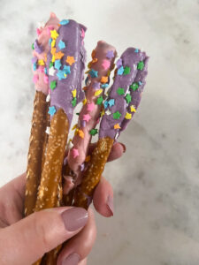 Pink and purple dipped pretzel snack.