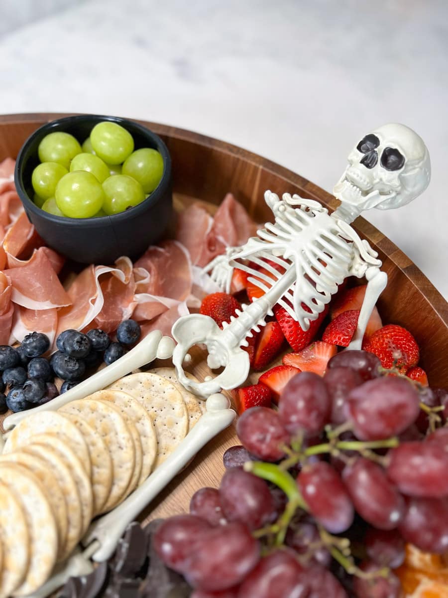 A toy skeleton as the centerpiece for a Halloween charcuterie board