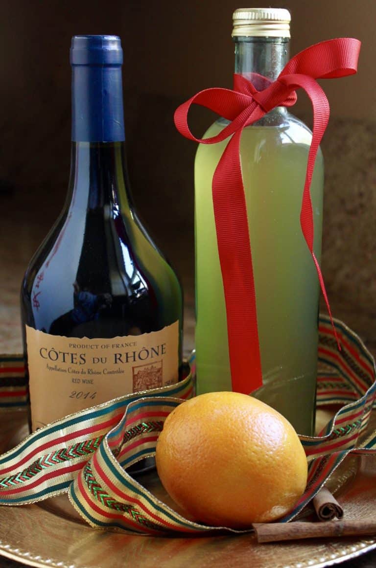 mulled cider in a tall bottle tied with red ribbon