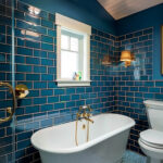 Bathroom with blue subway tile and blue patterned tile.