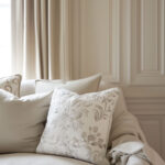 close up of a cream couch against a matching cream white wall as an example of white color drenching.