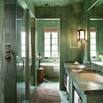 Green color drenched rustic bathroom.