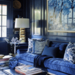 Blue painted living room with glossy navy paint on painted panneling, and a navy sofa with pillows.