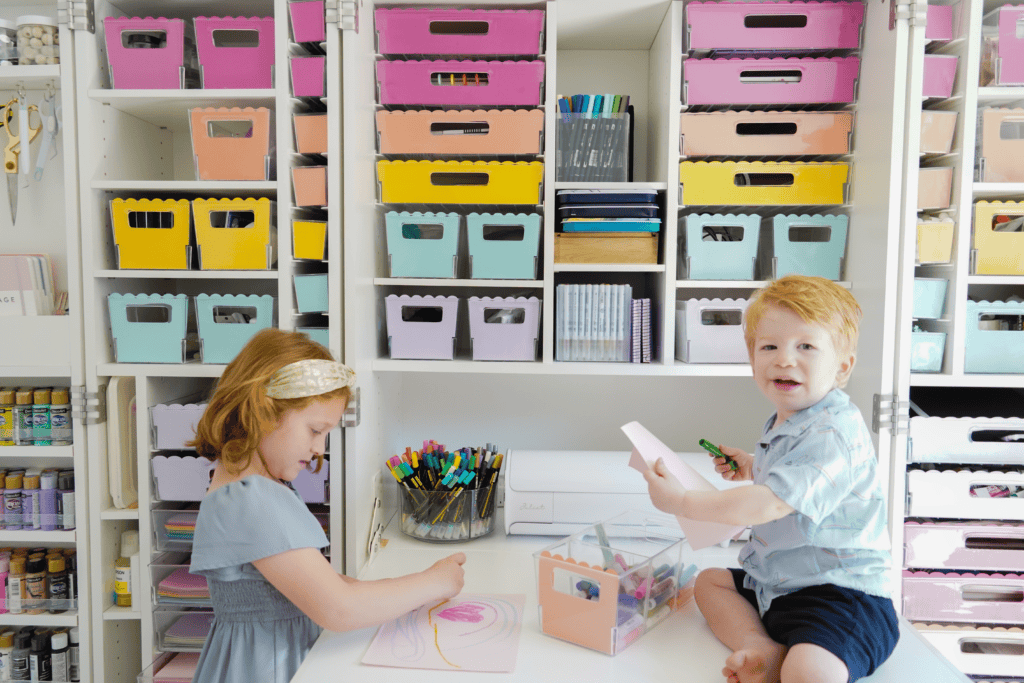 Toddler boy smiling on top of a desk