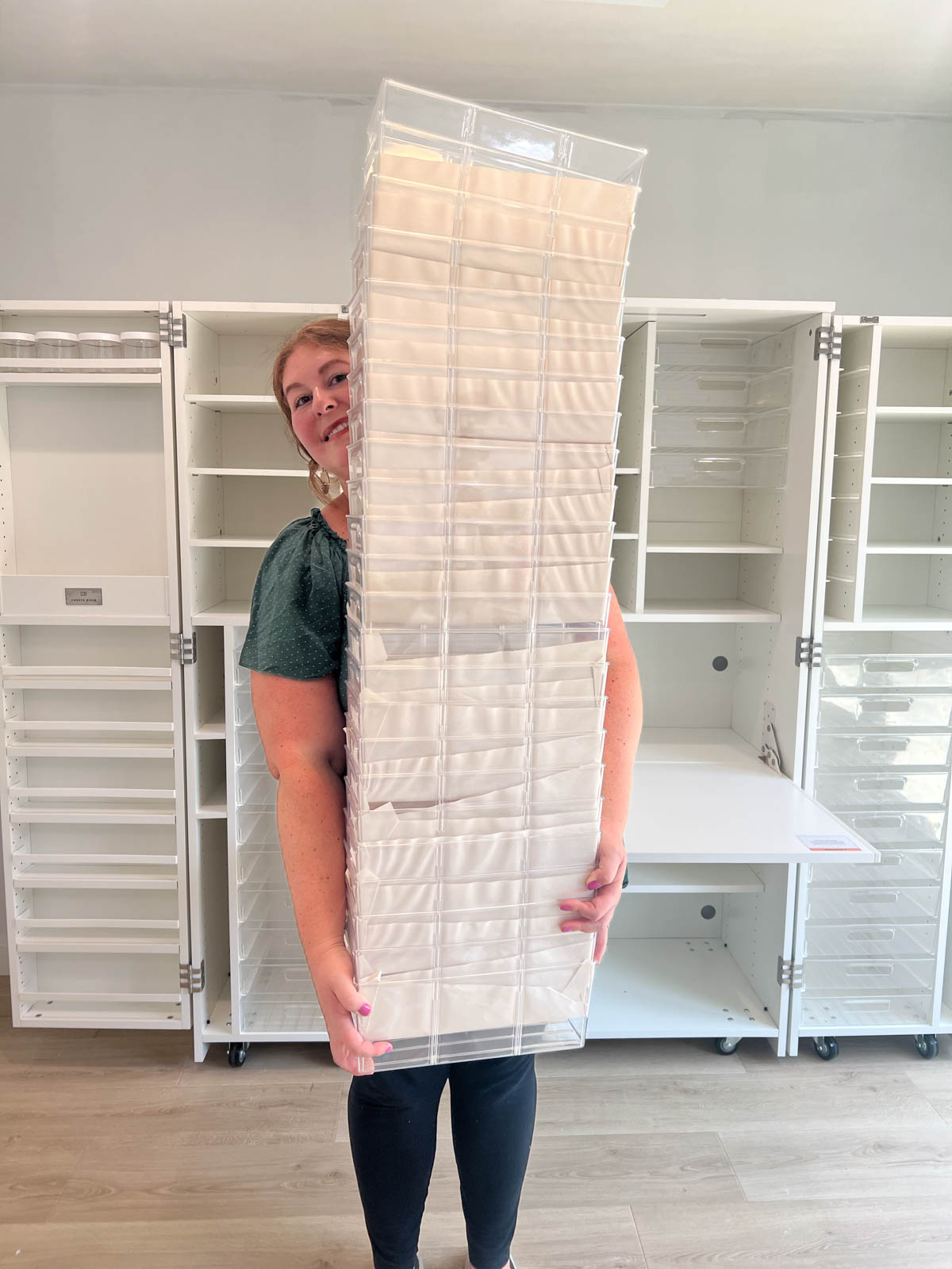 woman holding huge stack of interior totes