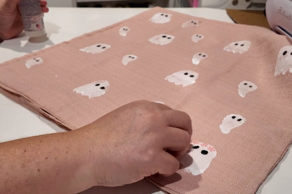 putting a flower sequin crown on ghost print