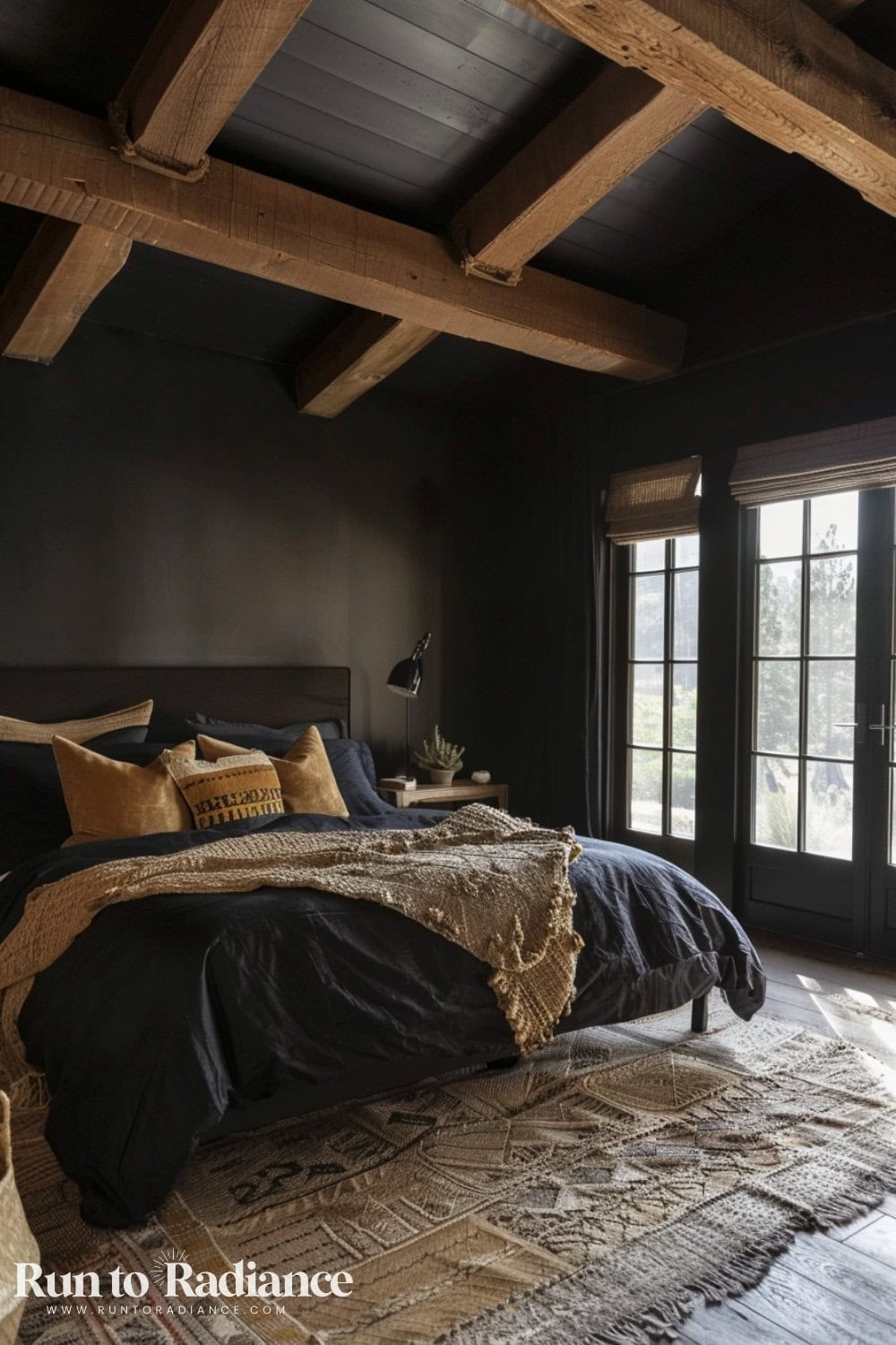 black bedroom with high ceilings and black bedding with pops of earthy browns