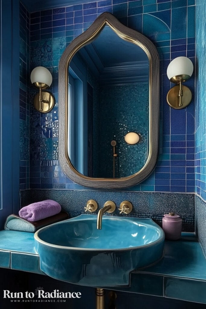 blue tiled bathroom with blue sink and gold accents