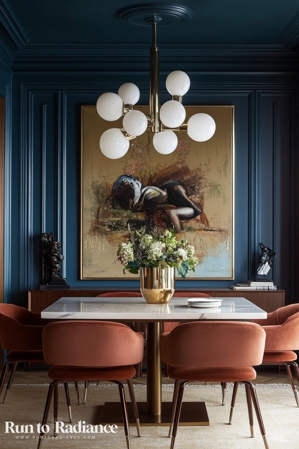 blue dining room with oversized art and orange chairs