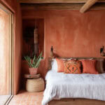 terracotta orange boho bedroom in a rustic setting