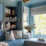 cozy reading nook with cushioned window seat, all painted blue