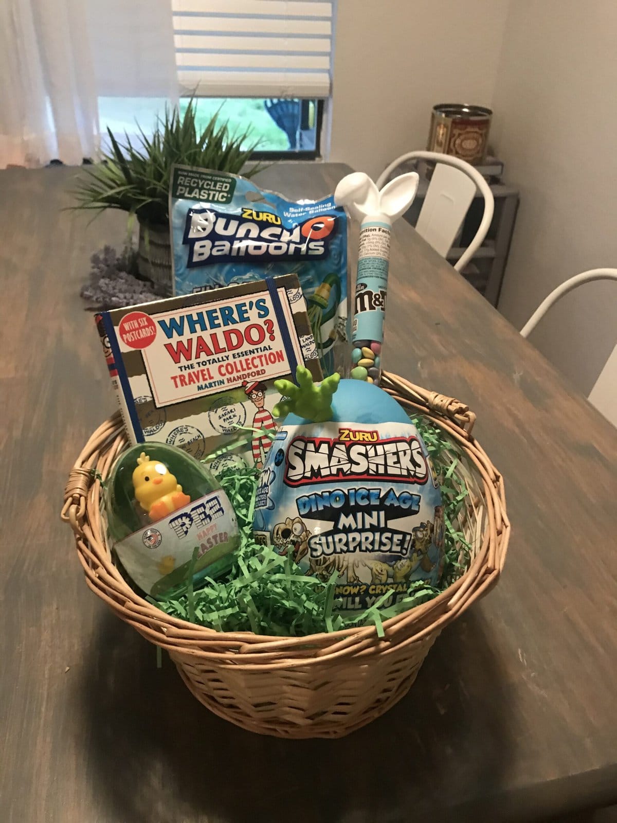 easter basket for kids filled with boys items including where's waldo, surprise egg and water balloons