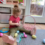 toddler sorting through plastic eggs