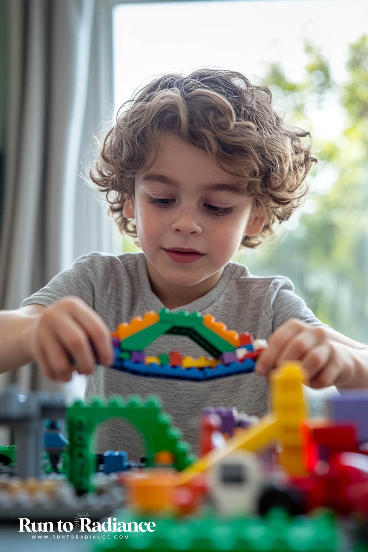 boy building a lego bridge