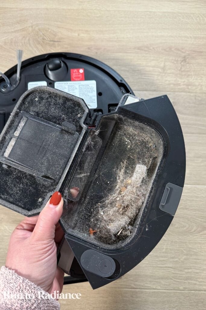 Roborock Q7 L5 dust bin full of debris after vacuuming session.
