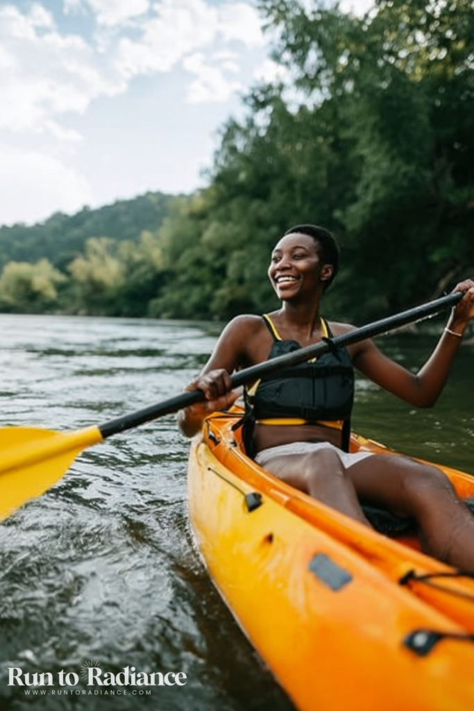 A teenage girl Kayaking in a river during the summer