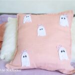close up of a pink diy ghost pillow made with yarn