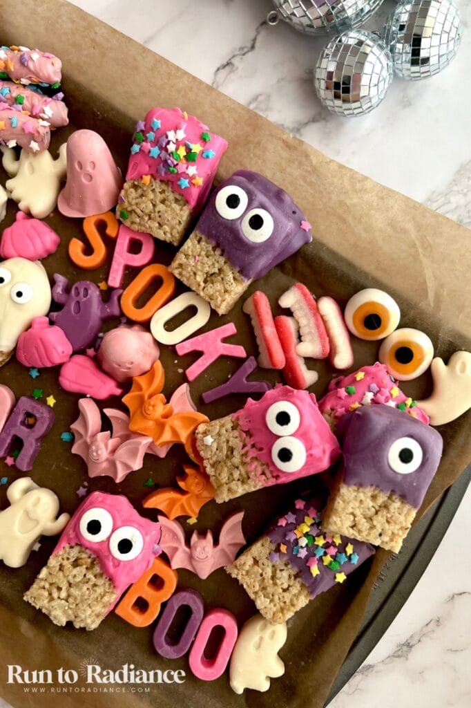 Halloween charcuterie board for kids - rice krispie treats, gummy teeth, gummy eyes, candy bats and ghosts