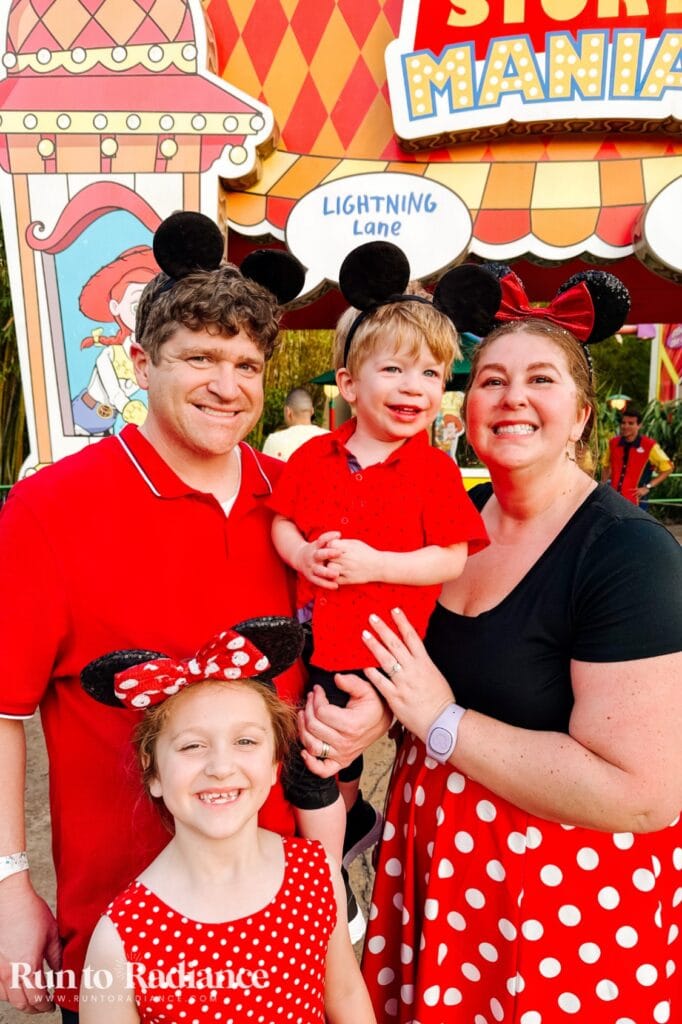 Disney family halloween costume idea with 4 people dressed in red with polka dots and mickey ears