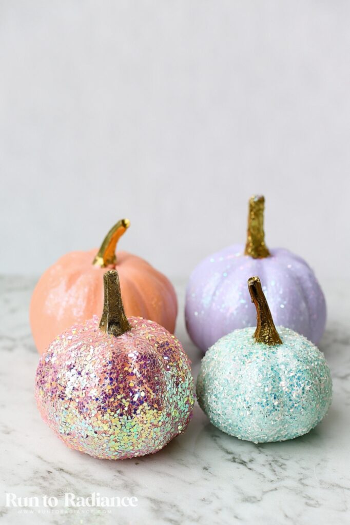 Painted pumpkins with iridescent chunky glitter on top