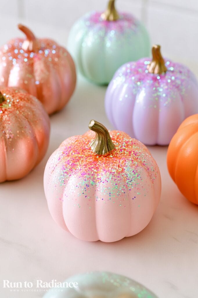 pastel colored pumpkins dropped with a sprinkle of glitter at the top