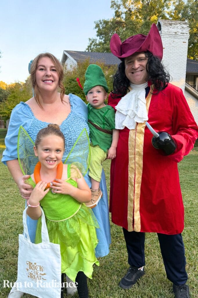 Family of four dressed as Peter Pan, Tinker Bell, Wendy and Captain Hook for Halloween