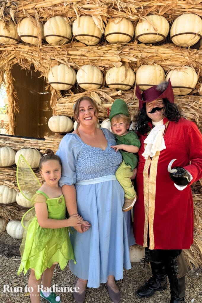 Family of four dressed as Peter Pan, Tinker Bell, Wendy and Captain Hook for Halloween