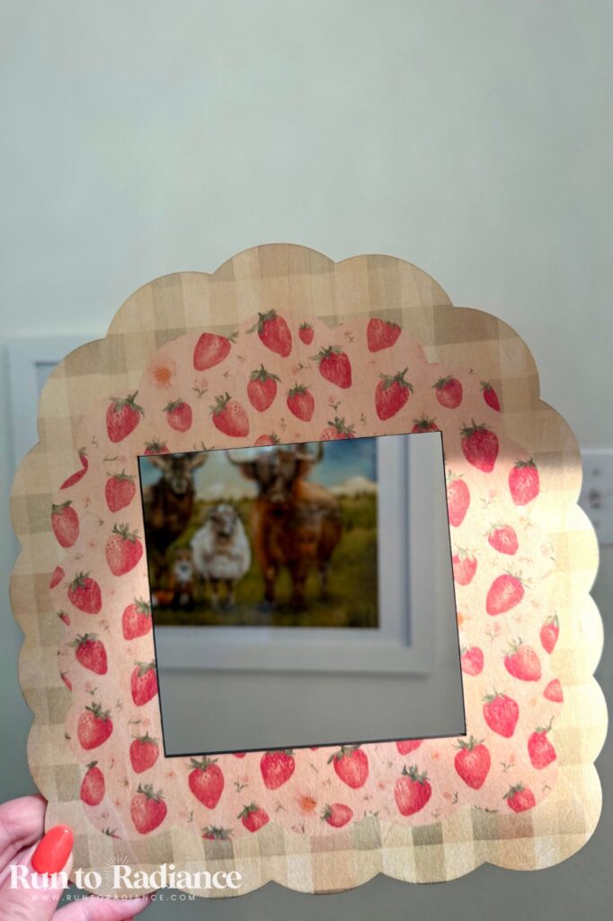 Hand holding a finished strawberry gingham scalloped picture frame