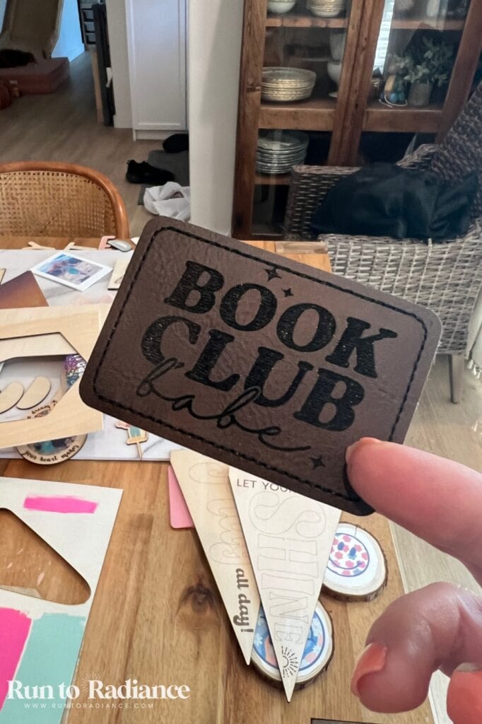 Engraved leather patch that says book club babe